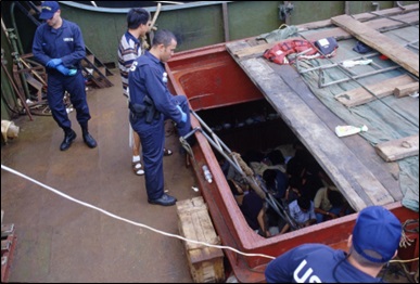 Color image of an August 1999 Coast Guard interdiction of Motor Vessel Yu Xing. The ship was interdicted north of Midway Island with 75 migrants from the People’s Republic of China.  Color image of an August 1999 Coast Guard interdiction of Motor Vessel Yu Xing. The ship was interdicted north of Midway Island with 75 migrants from the People’s Republic of China.